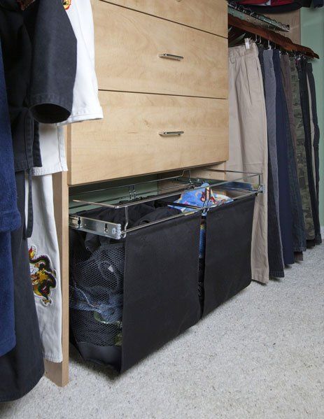 A closet filled with clothes and a laundry basket