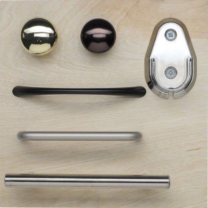 A bunch of different types of handles and knobs on a wooden surface