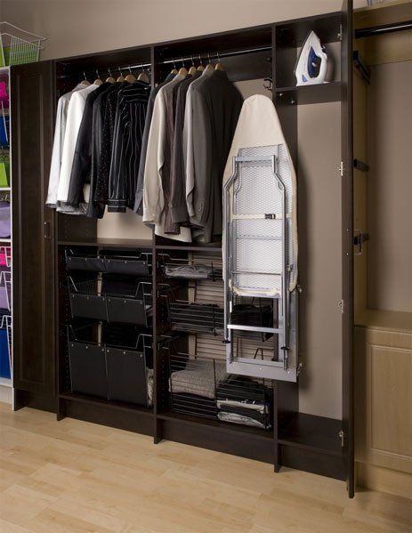 A closet filled with clothes and an ironing board