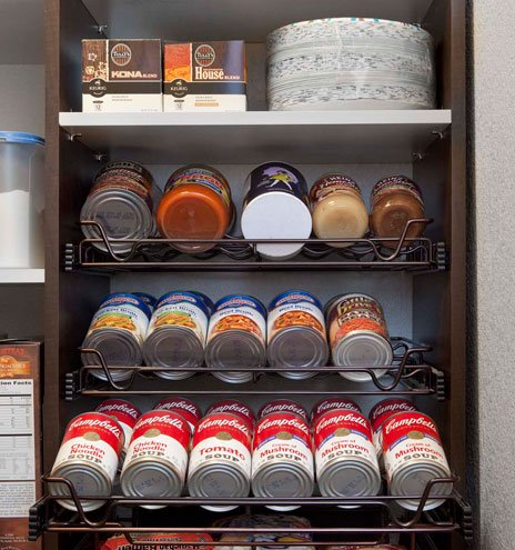 A pantry filled with cans of soup and fruit.