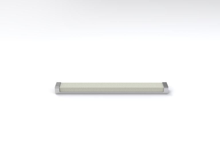 A white bar with a metal handle is sitting on a white surface.