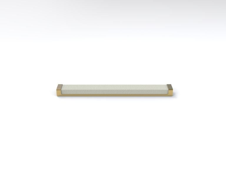 A white bar with a gold handle on a white surface.
