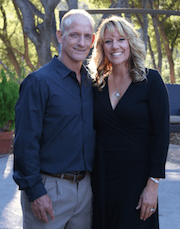 A man and a woman are posing for a picture together.