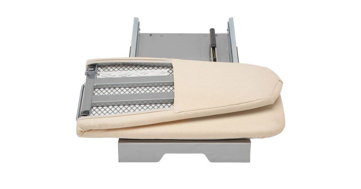 A white ironing board with a beige cushion on top of it.