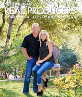 A man and a woman are standing next to each other in the grass.