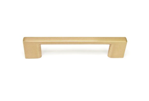 A gold cabinet handle on a white background.