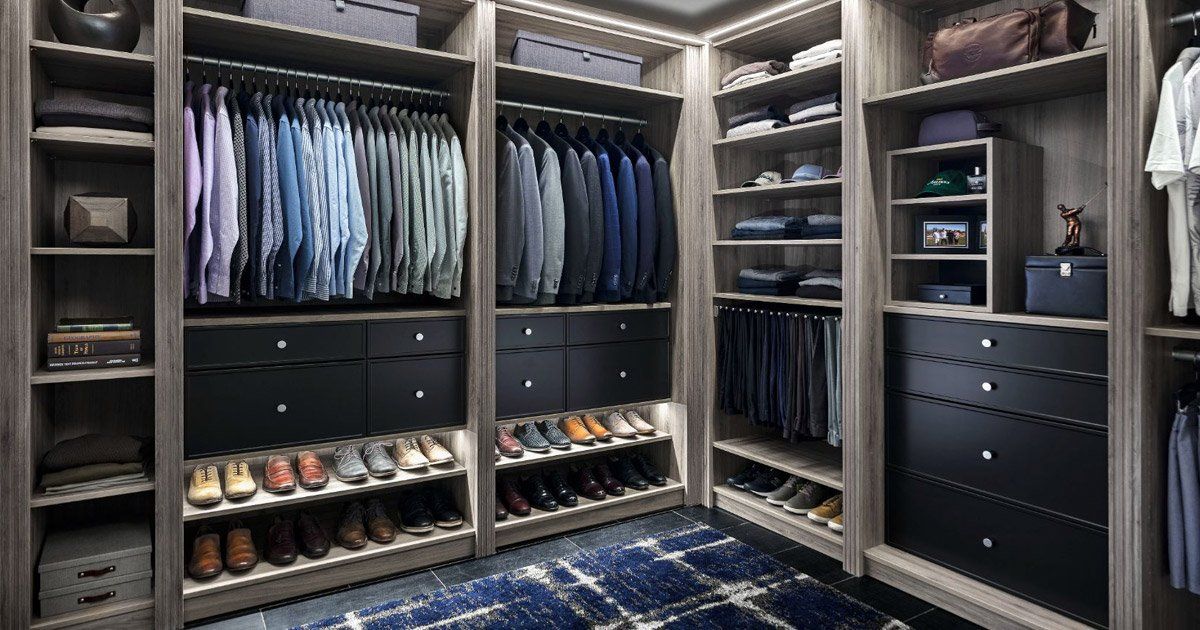 A walk in closet filled with lots of clothes and shoes.
