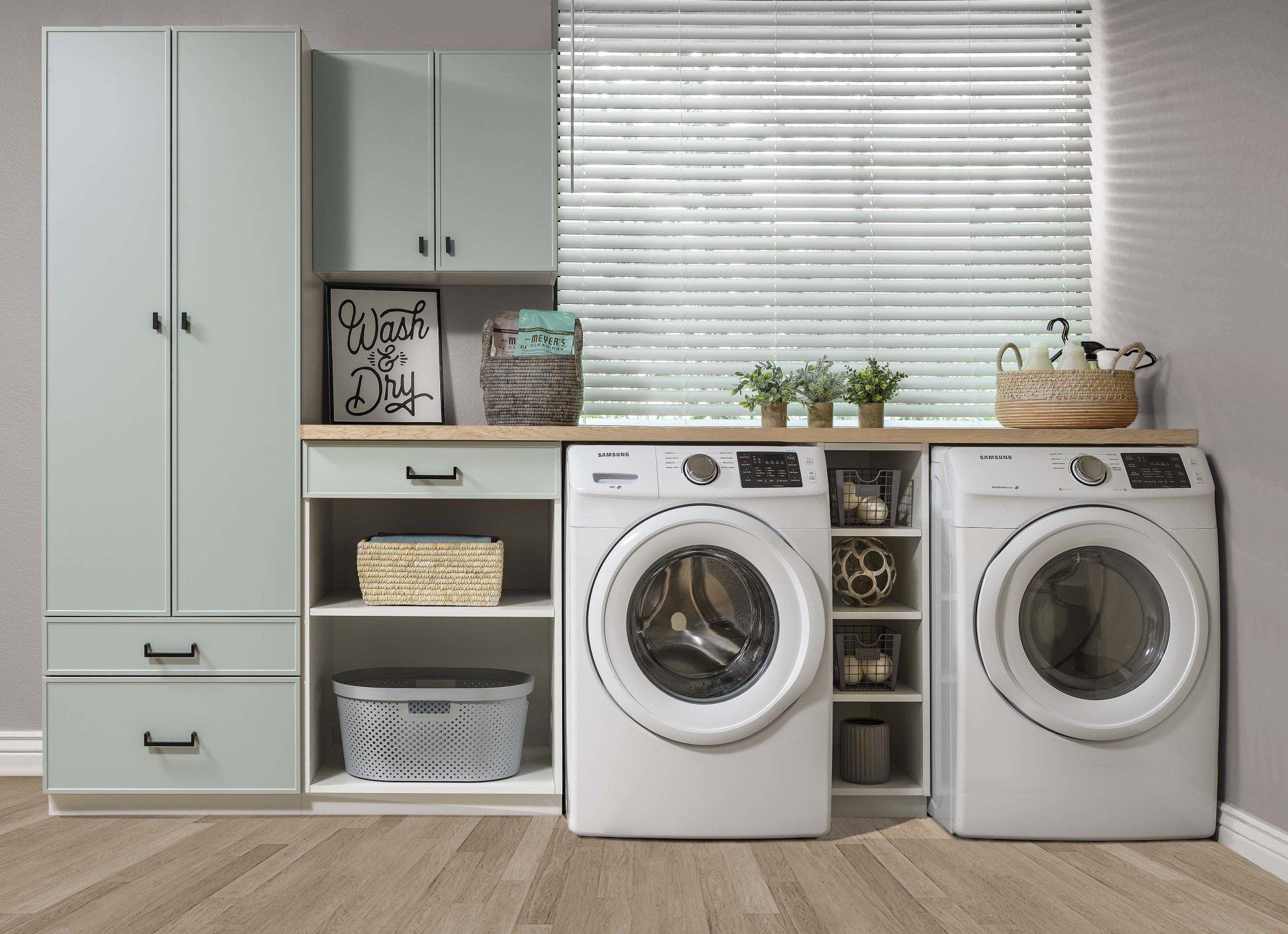 A laundry room with two washing machines and a window.