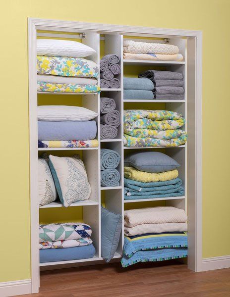 A closet filled with blankets pillows and towels