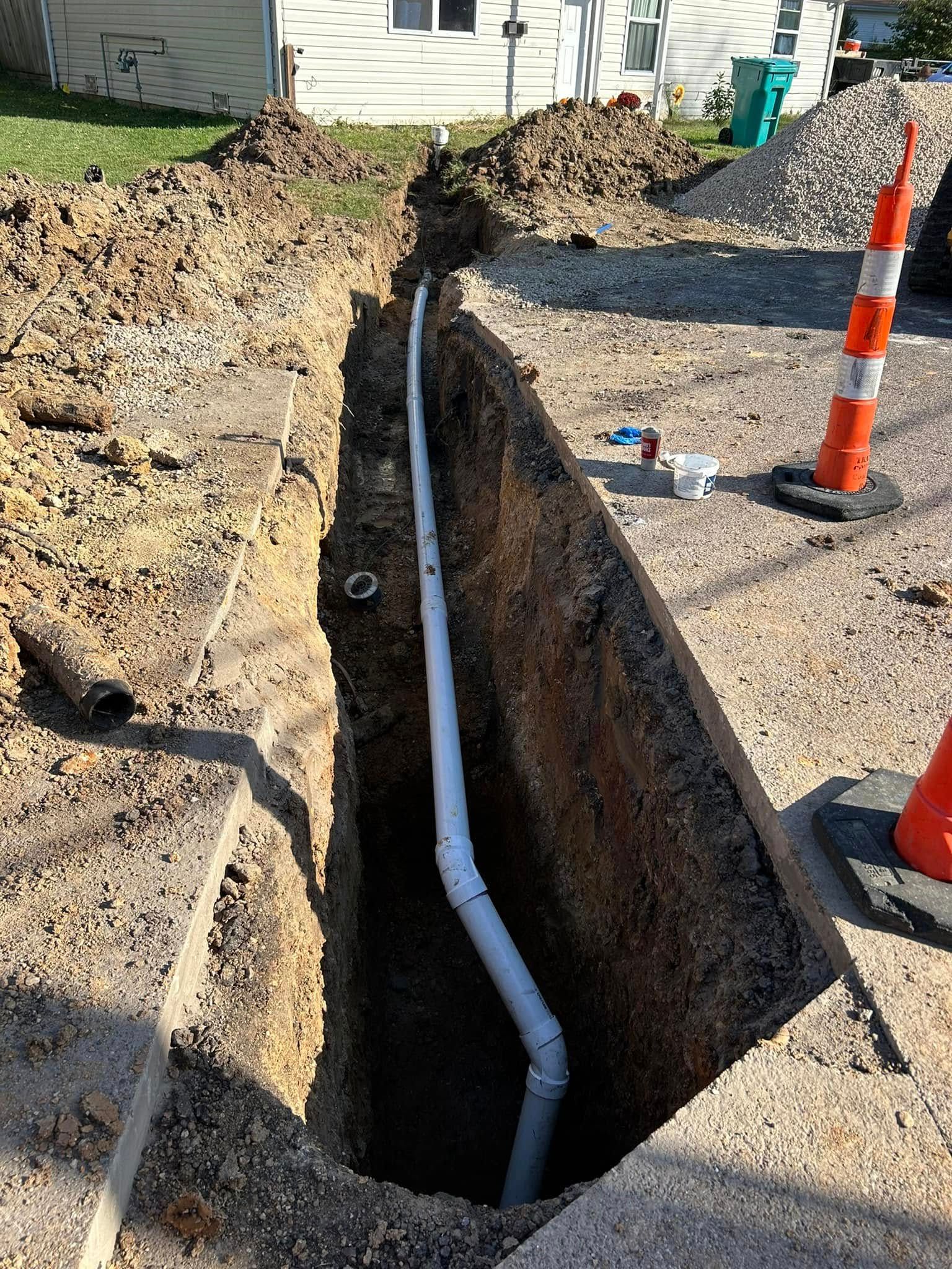 Woman in straw hat smiles, holding wine glass near a lake.