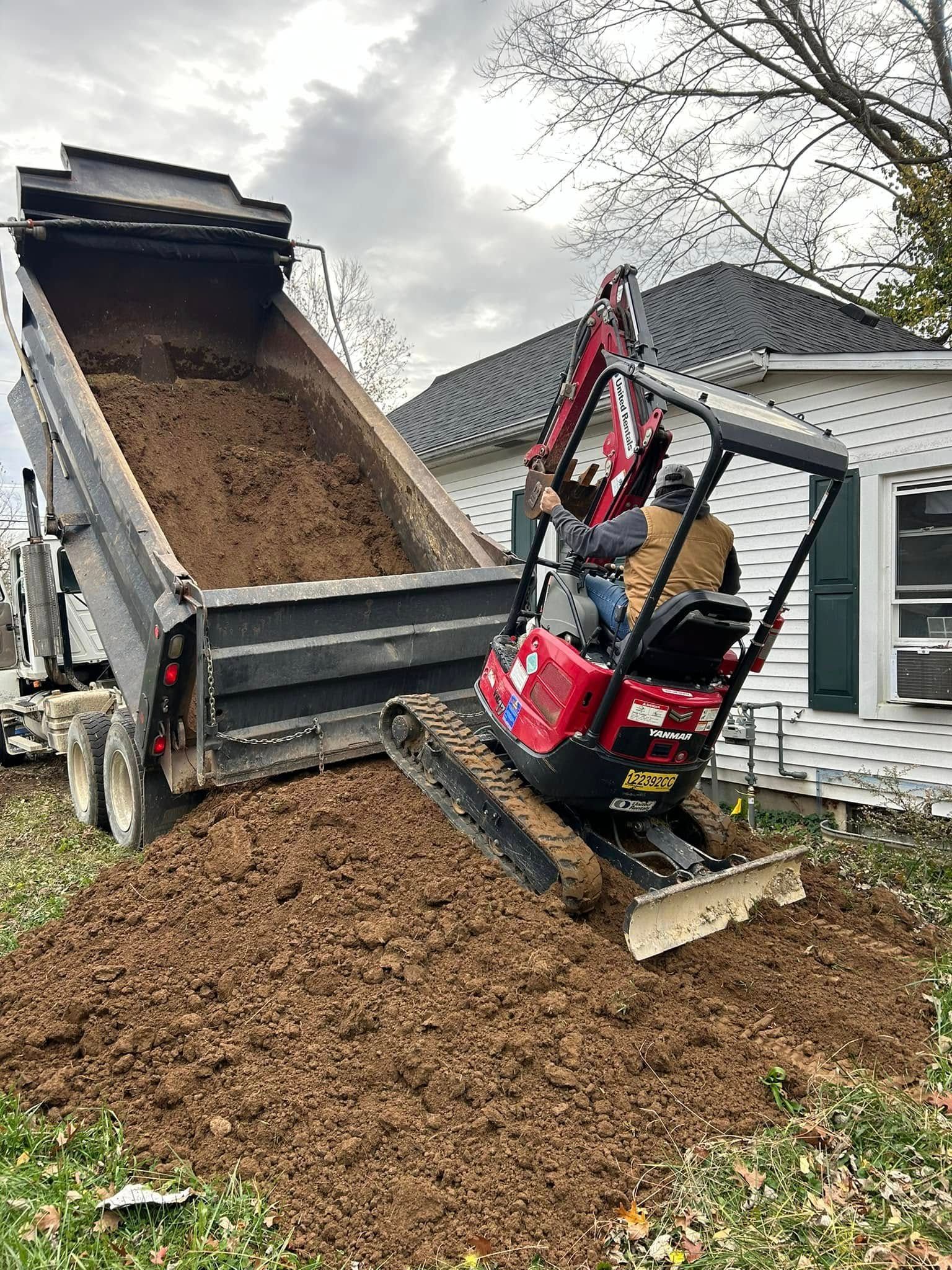 Woman in straw hat smiles, holding wine glass near a lake.