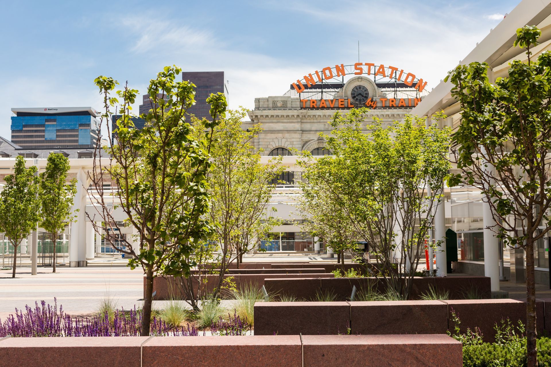 Regent Park Apartments entrance with black awning, brick facade, and glass staircase.