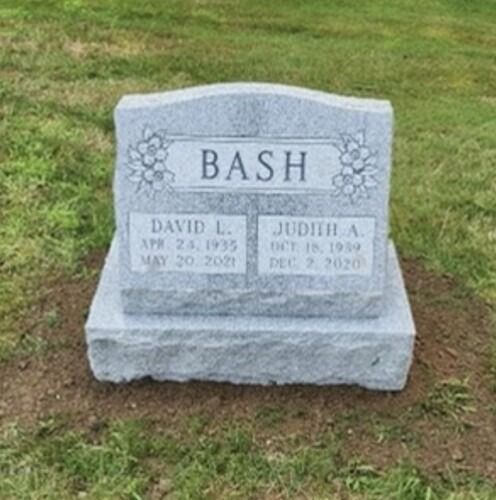 Gray headstone with the name BASH, listing the dates of birth and death for David L. and Judith A.