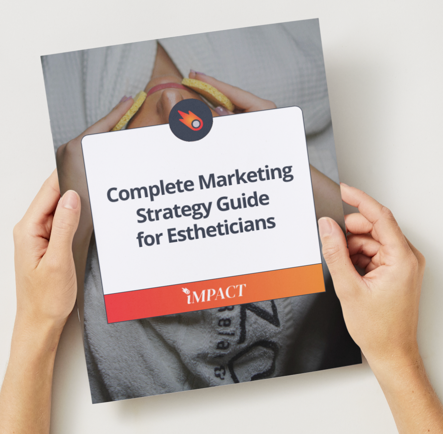 Hands holding a guide titled “Complete Marketing Strategy Guide for Estheticians.” The guide has orange, red, and white text.