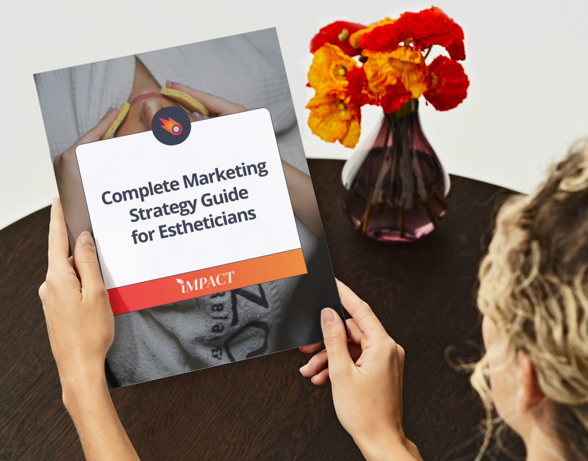 Hands holding a guide titled “Complete Marketing Strategy Guide for Estheticians.” The guide has orange, red, and white text.