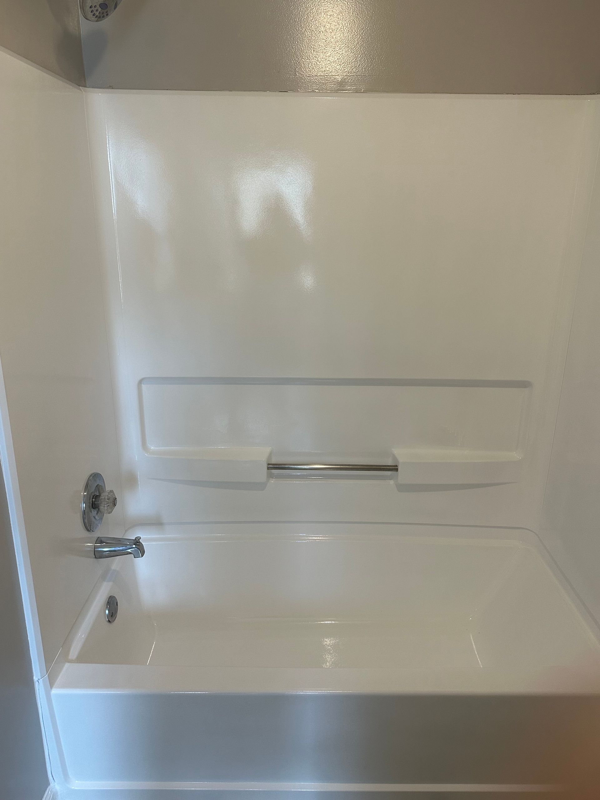 A bathroom with a bathtub and shower stall.