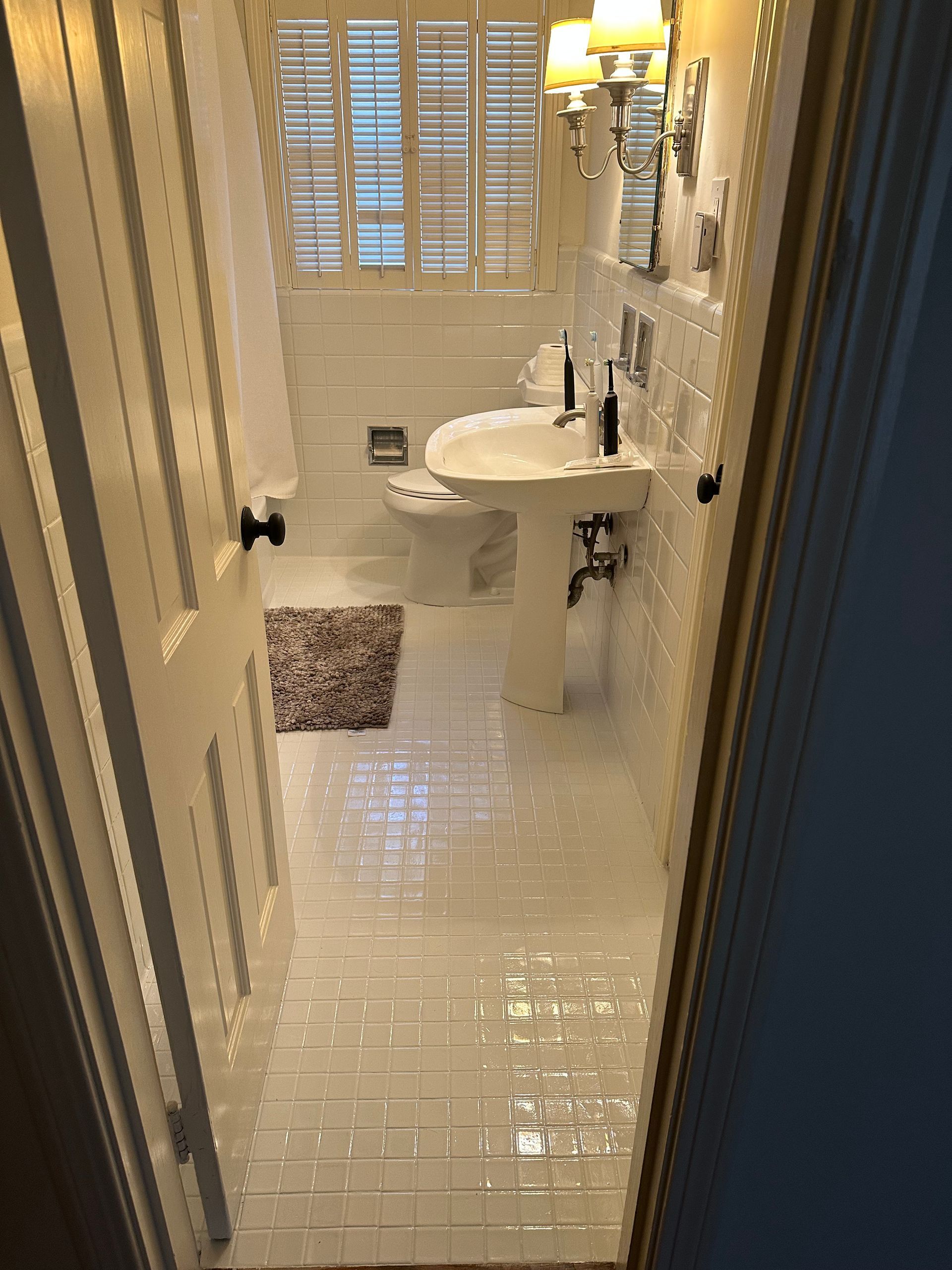 A bathroom with a sink , toilet , and mirror.