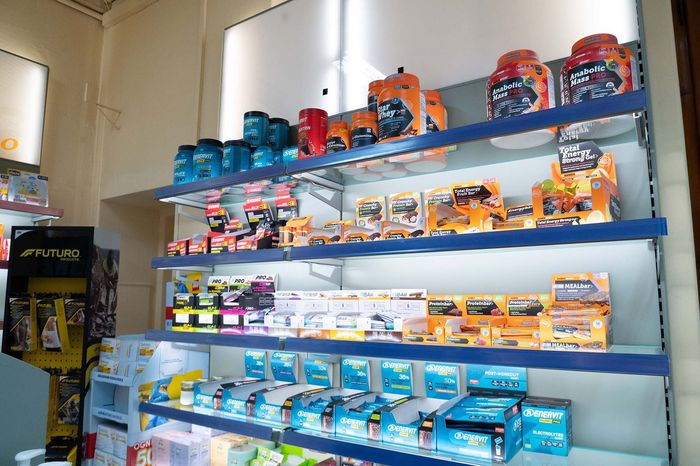 Flaconi di integratori alimentari a base di Omega-3 e olio di pesce disposti su uno scaffale di un negozio.