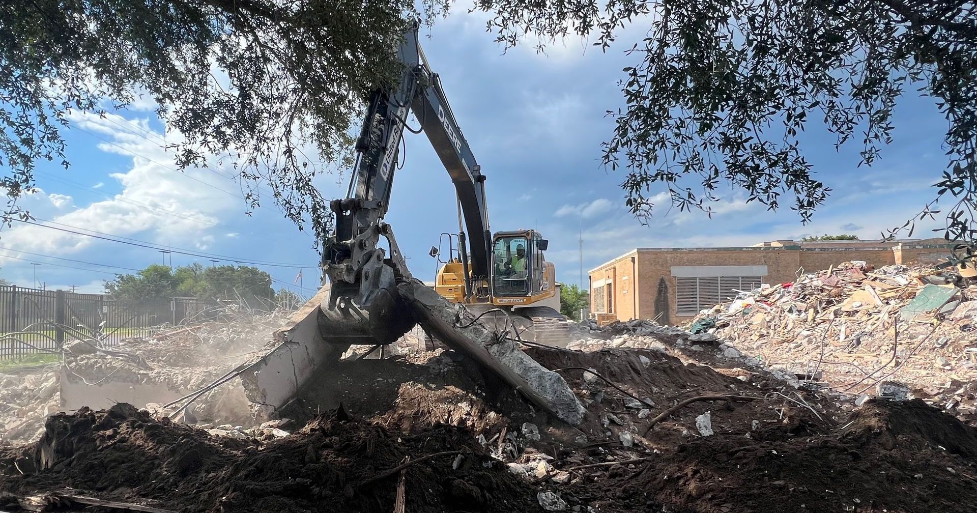 Excavator demolishing a house in McAllen, TX.