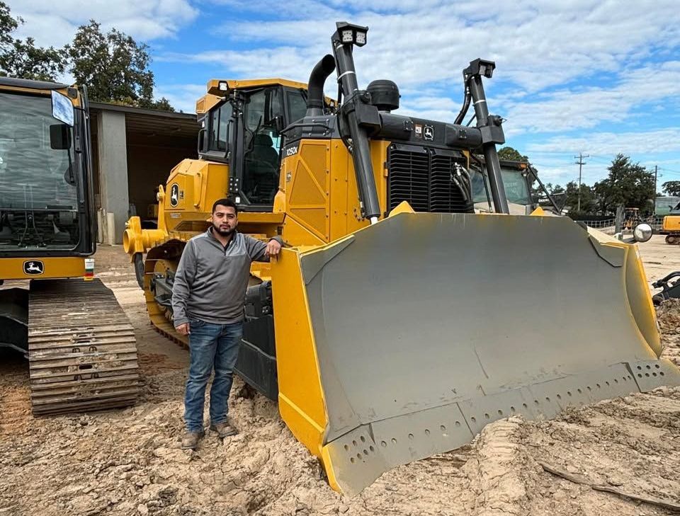 Excavator for hire on top of a mound of dirt in McAllen, Tx.