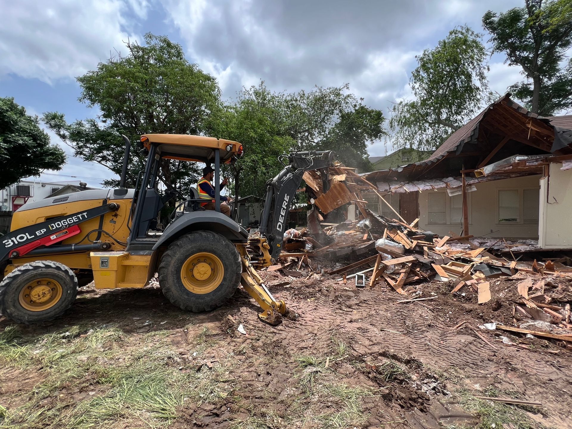 Backhoe tearing down a house in Pharr, TX.