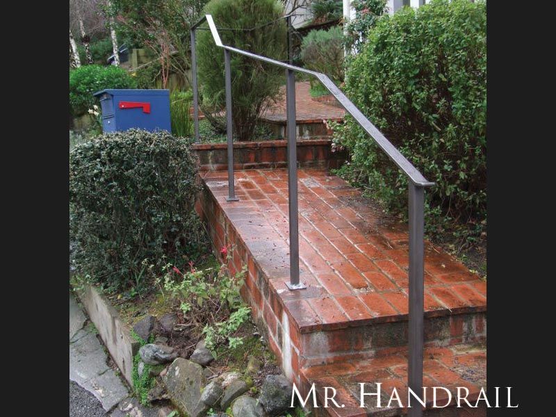(EX-6) - Flatbar handrail with simple top rail termination and no bolts showing on the baseplates.
