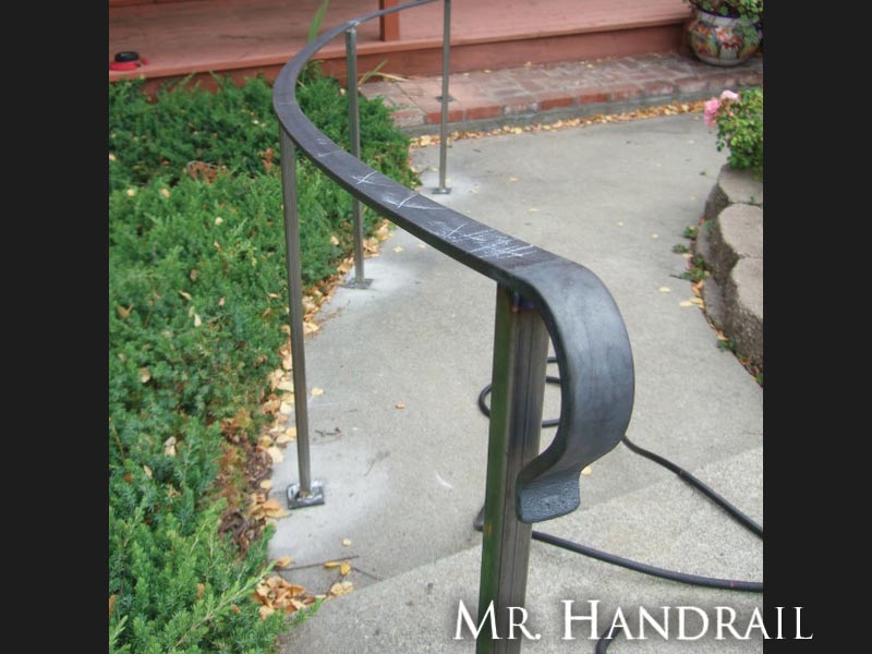 (EX-18) - Radius flatbar handrail under construction (note chalk marks on top).