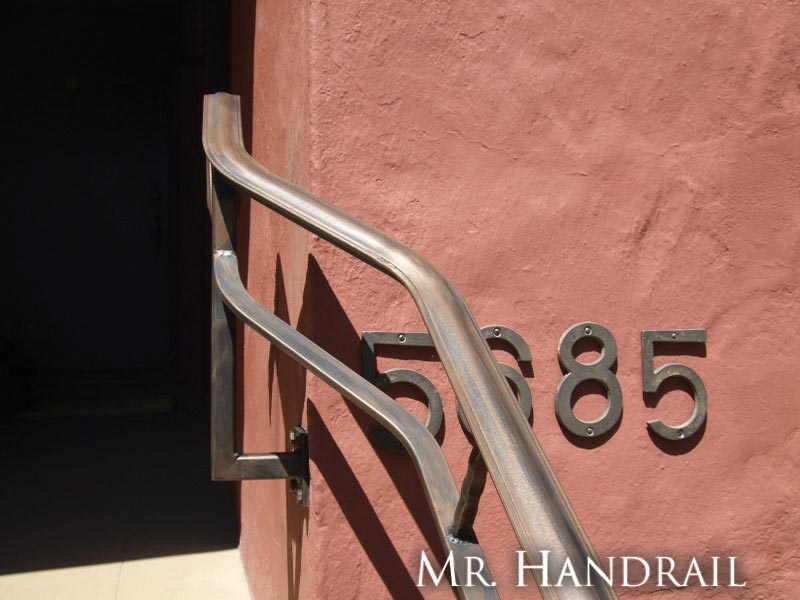 (CU-6) - This handrail leads to the front door to an arts and crafts style home