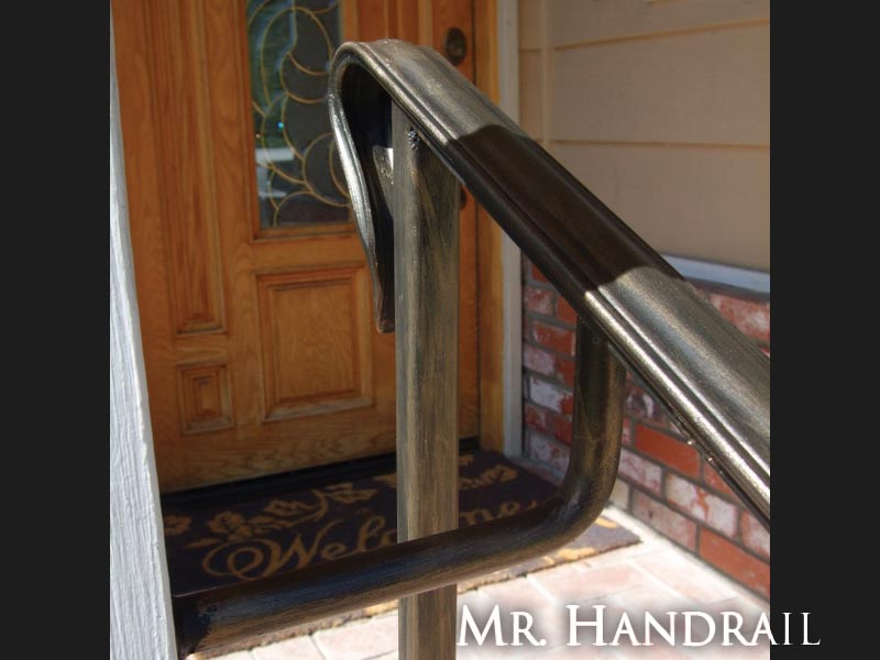 (EX-63) - Bronze handrail bracketed to post for strength
