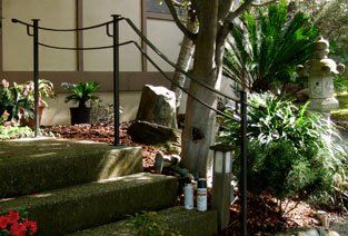 handrail curving down brick stairs