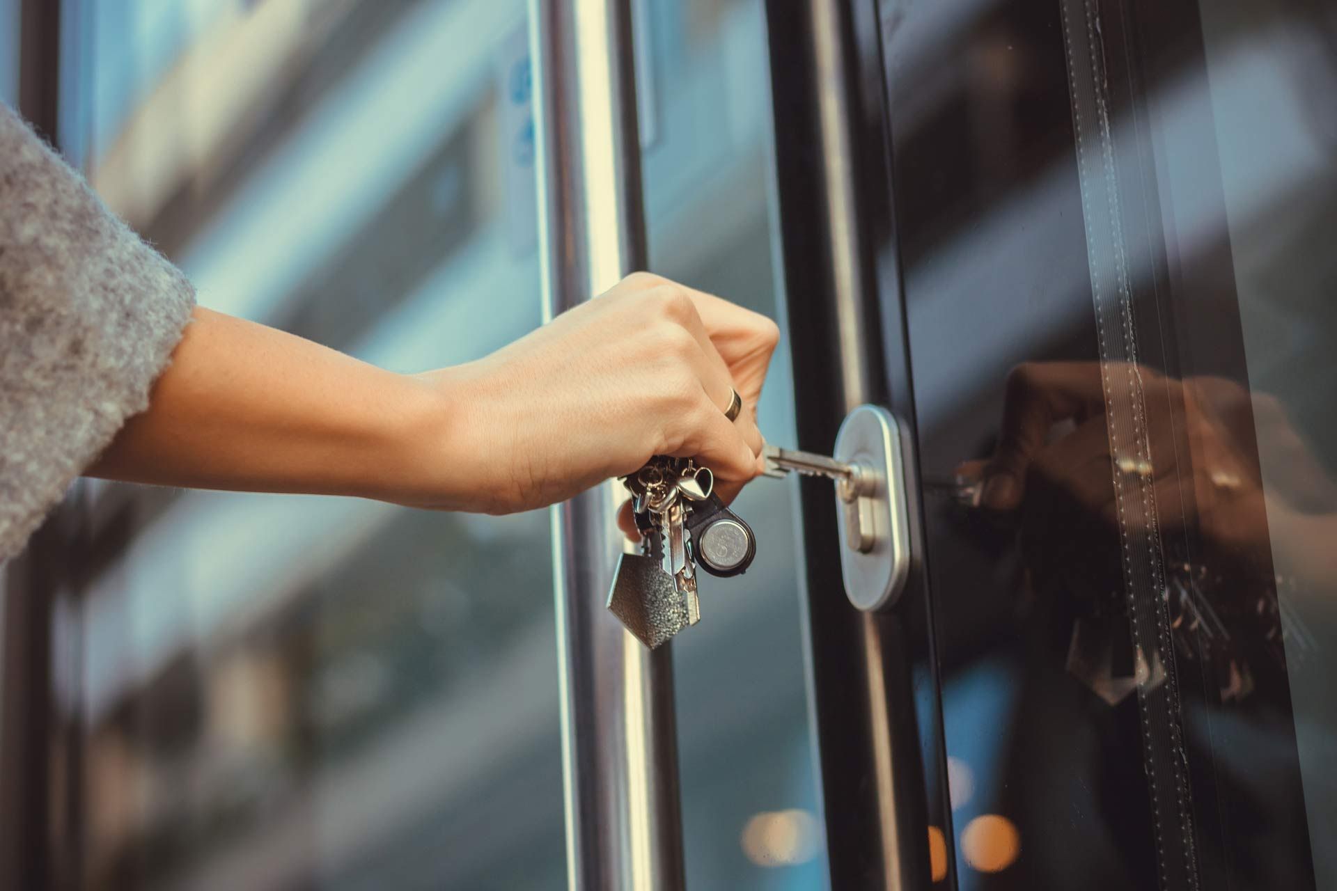 A person is opening a door with their hand.