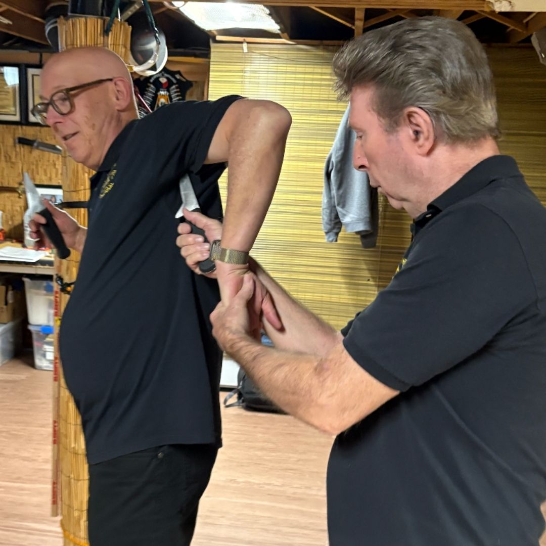 A woman is looking at a bag of food in a grocery store.