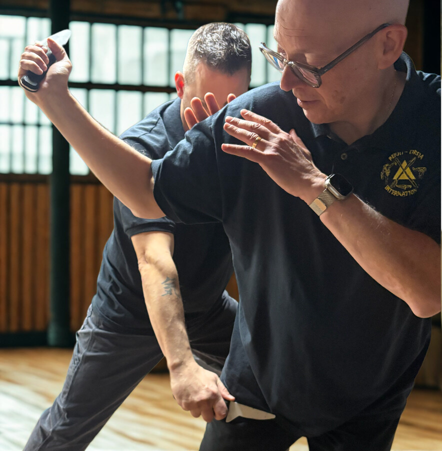 girl kicking a black back in a kickboxing studio