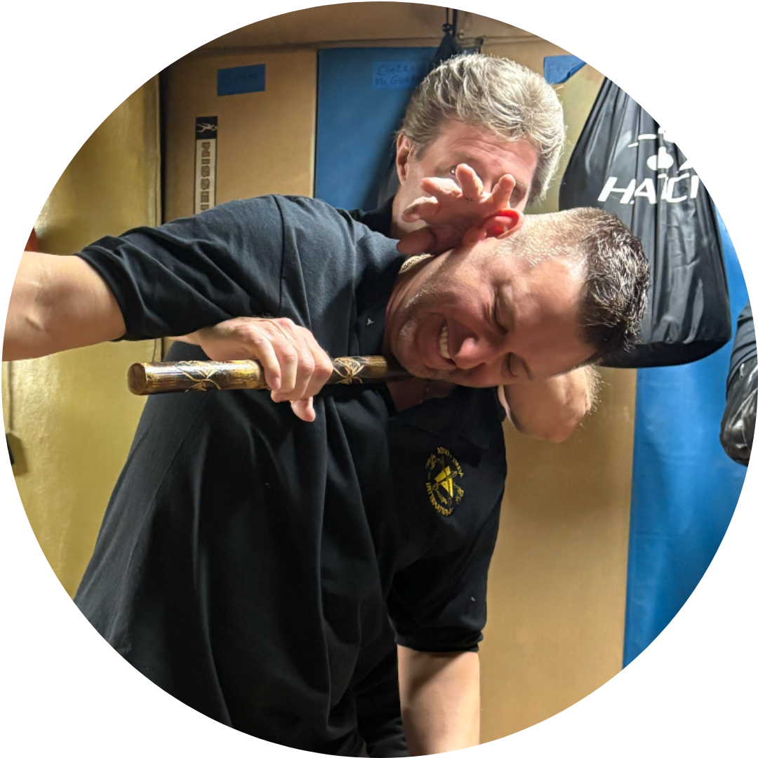A woman is boxing with a man in a gym