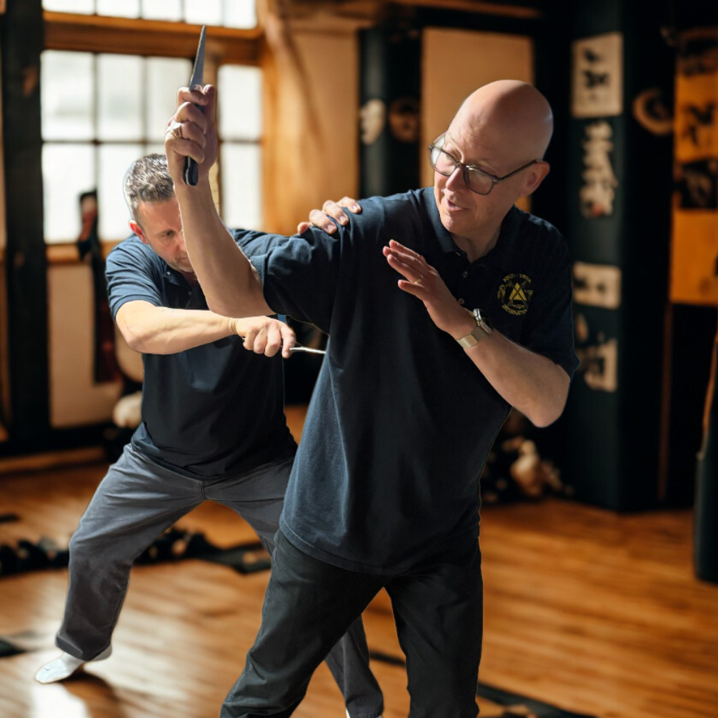 A woman is sitting on a bed with her head in her hands.