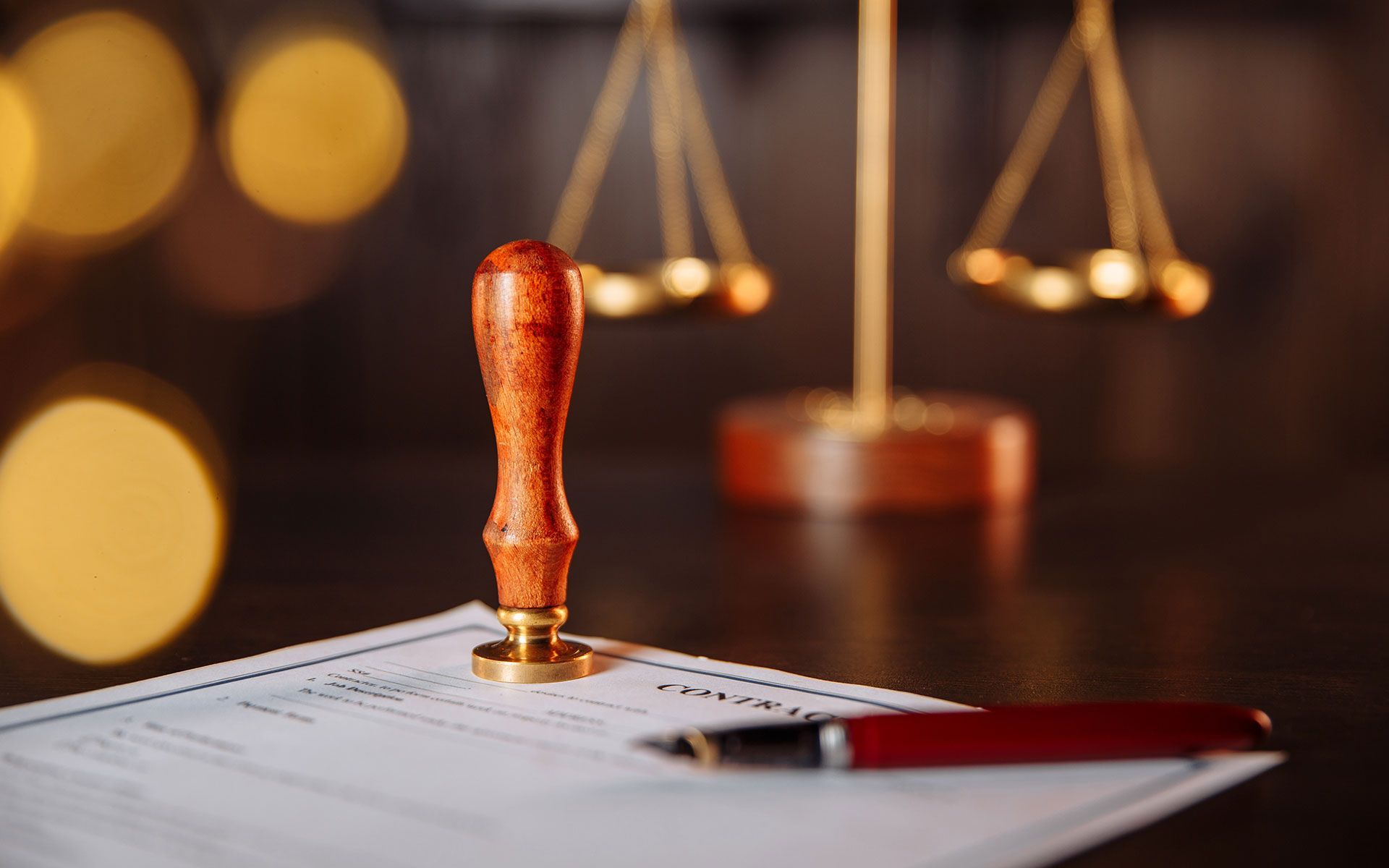 A document with a red pen and seal, with a balance scale in the background.