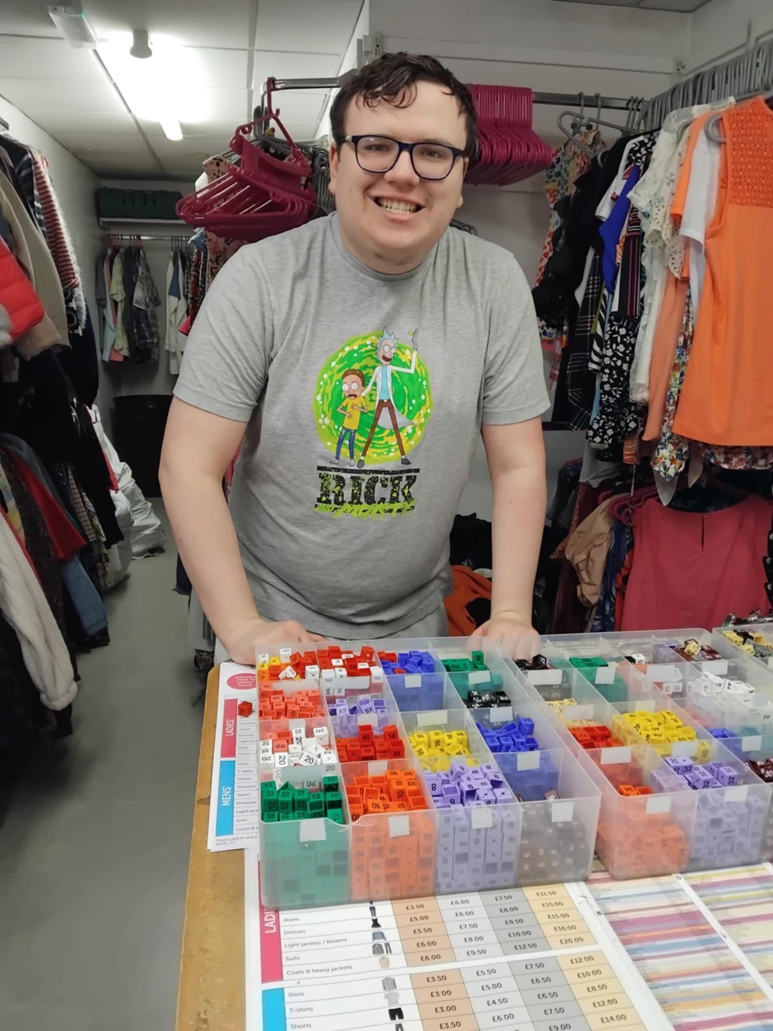 A man wearing a grey shirt with the word Rick on it