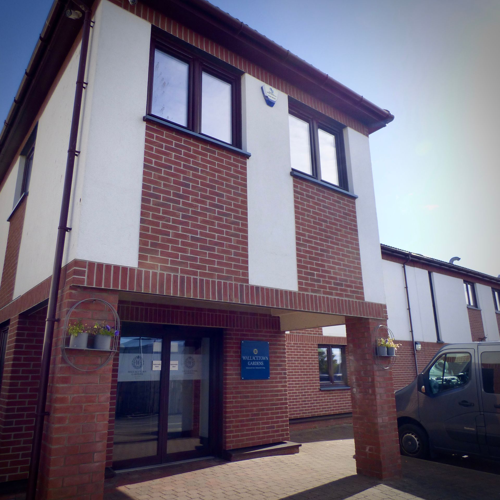 A brick building with a blue sign that says ' ambulance ' on it