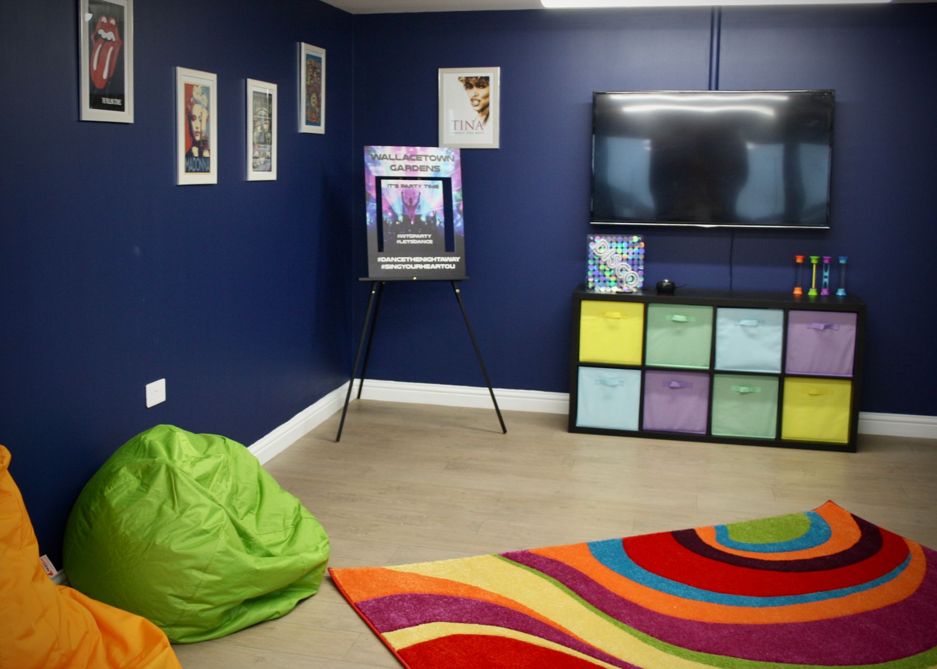 A room with blue walls and a colorful rug