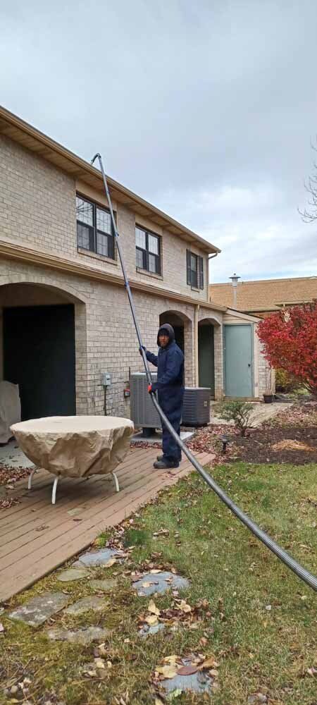 Man Cleaning a Gutter