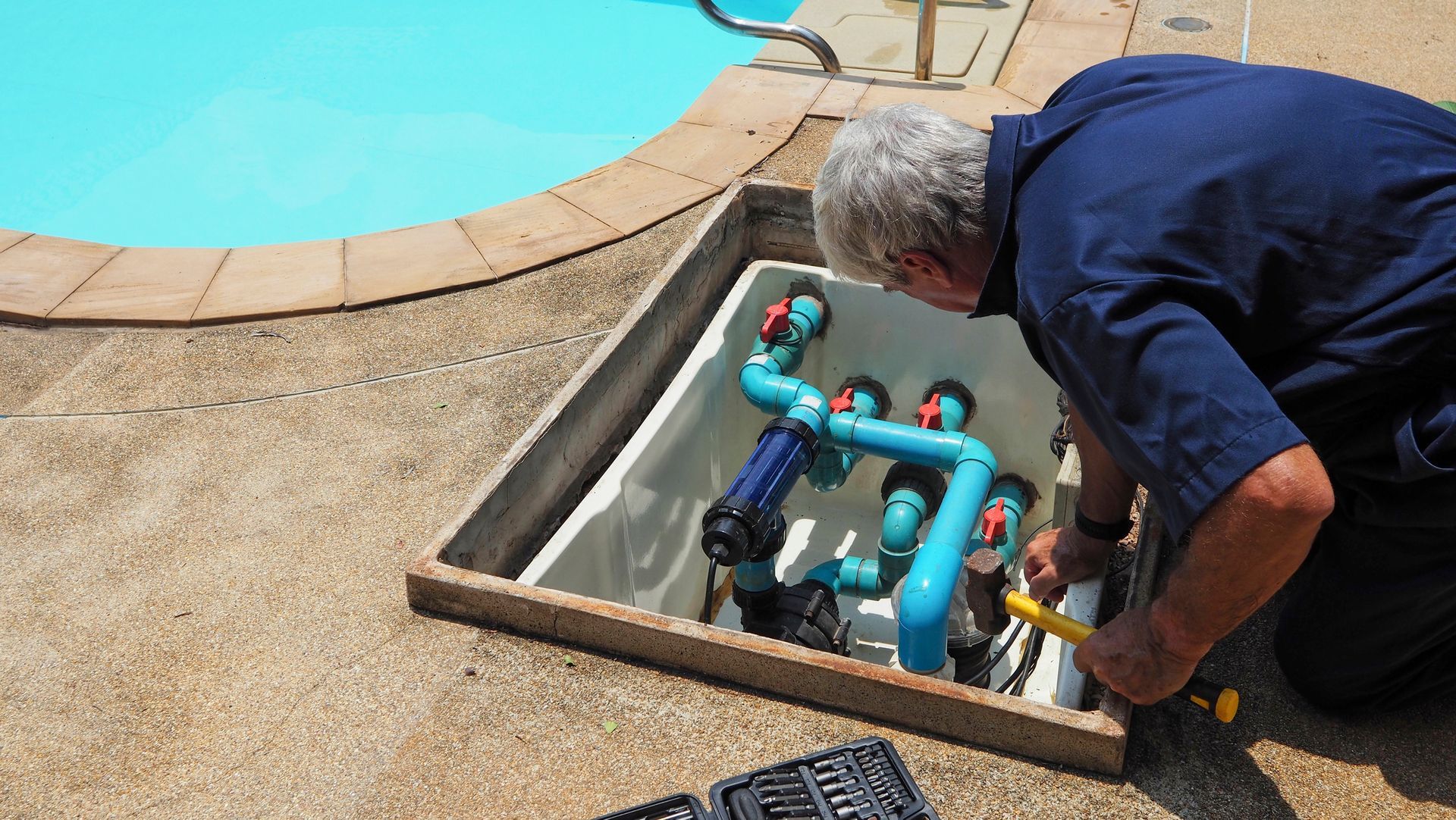 Technician ensuring functionality of a swimming pool water pump.