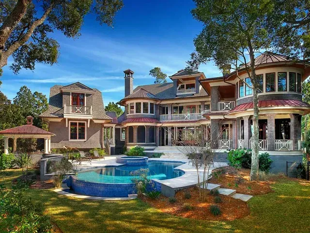 A large house with a large pool in the backyard