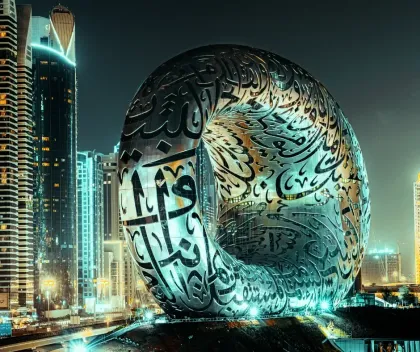 Museum of the Future in Dubai, a large, ornate building with Arabic calligraphy, illuminated at night.