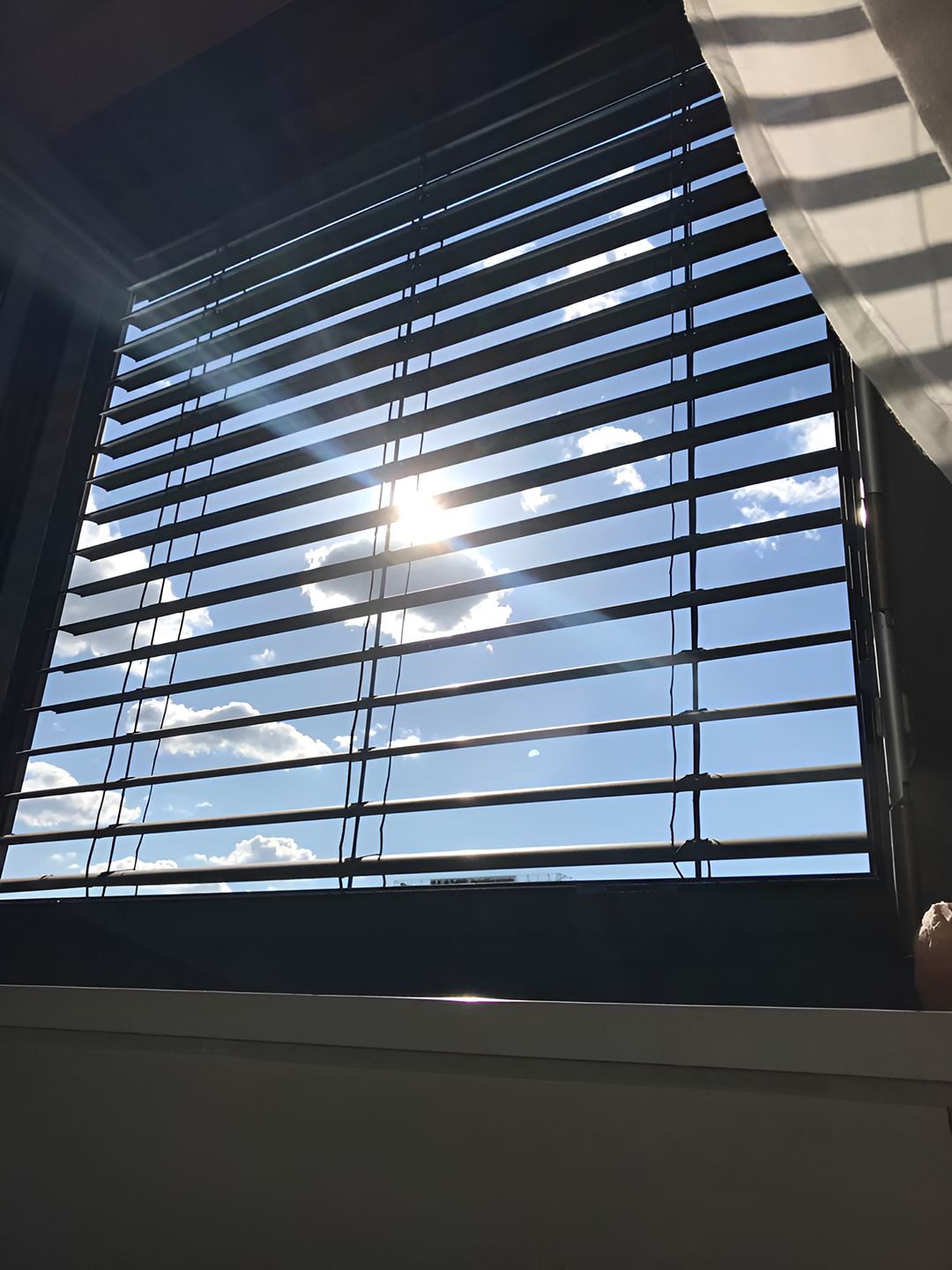 The Sun Is Shining Through The Blinds Of A Window — Ron Ayton Curtains, Blinds & Shutters In Cooranbong, NSW