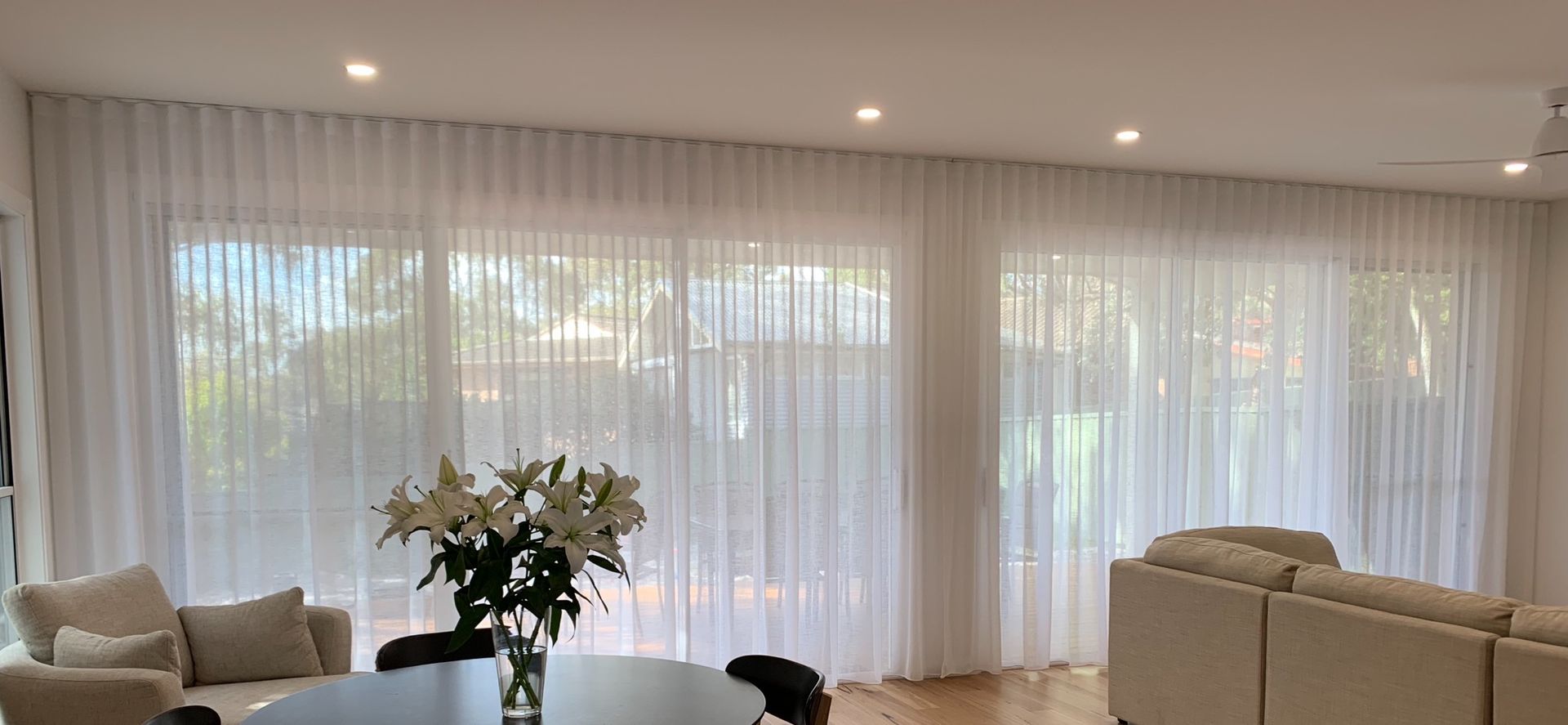 There Is A Vase Of Flowers On The Table In The Living Room — Ron Ayton Curtains, Blinds & Shutters In Shelly Beach, NSW