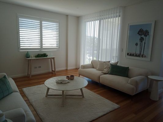 A Living Room With A White Couch — Ron Ayton Curtains, Blinds & Shutters In Shelly Beach, NSW