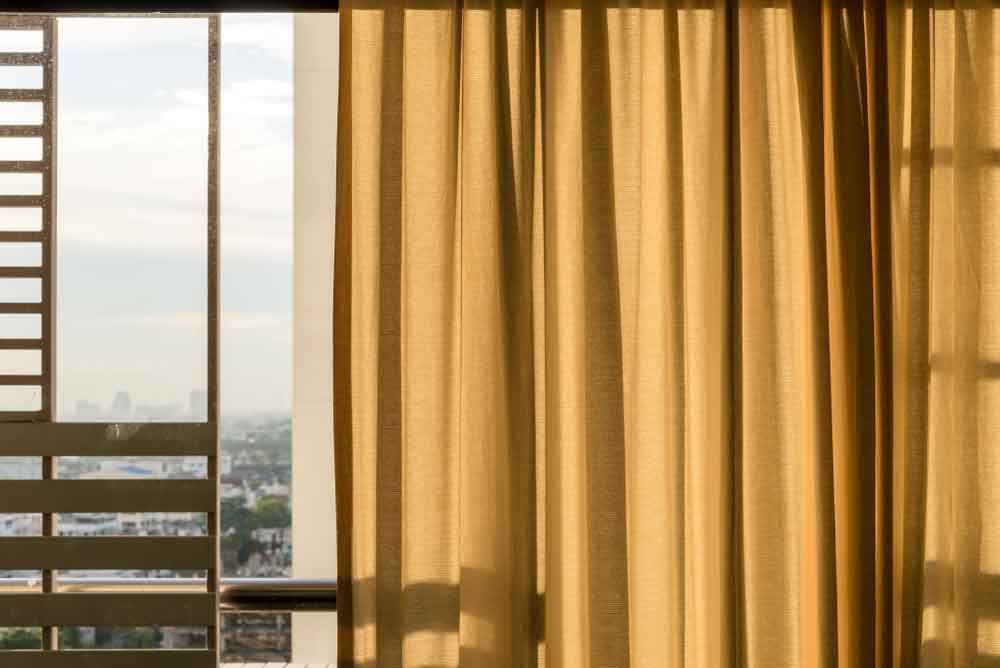 A Window With Yellow Curtains — Ron Ayton Curtains, Blinds & Shutters In Shelly Beach, NSW