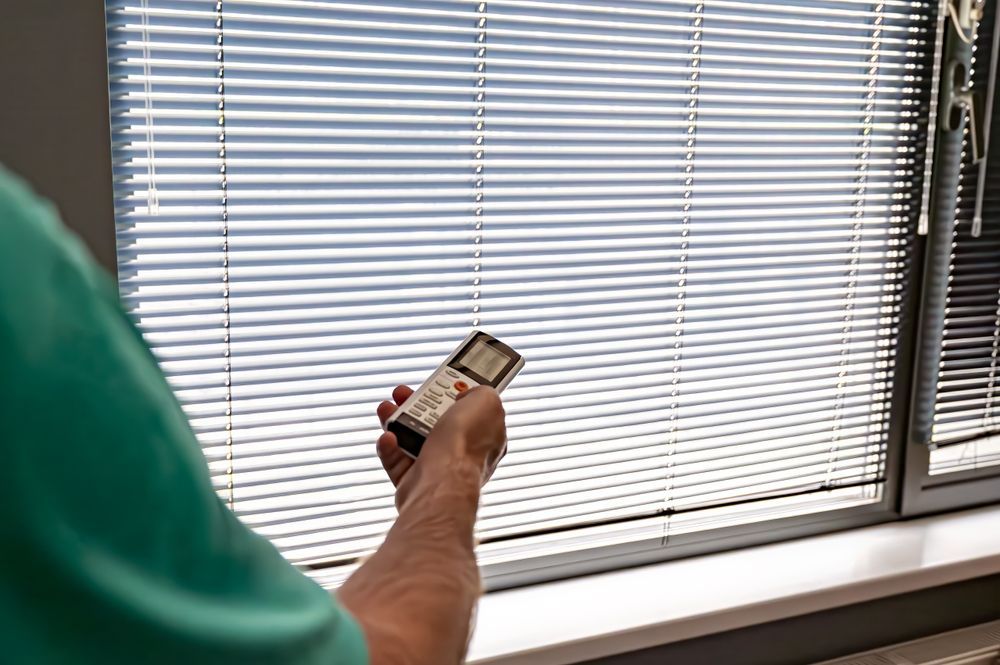 Person Using Remote Control on Motorised Blinds