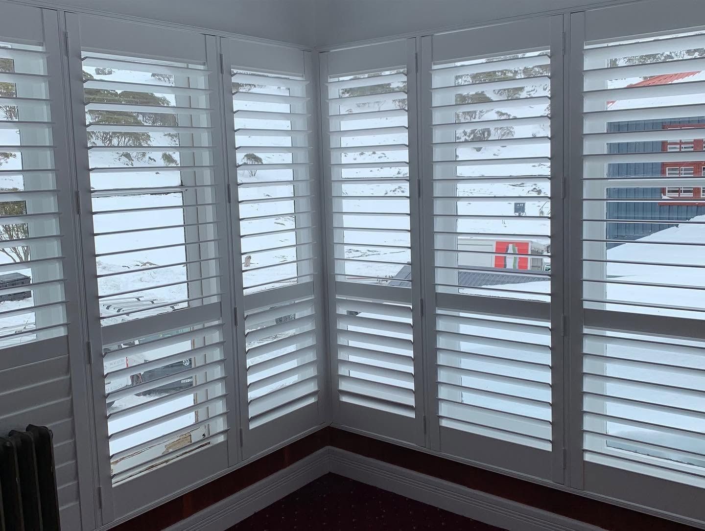 Room with White Window Covered by Shutters