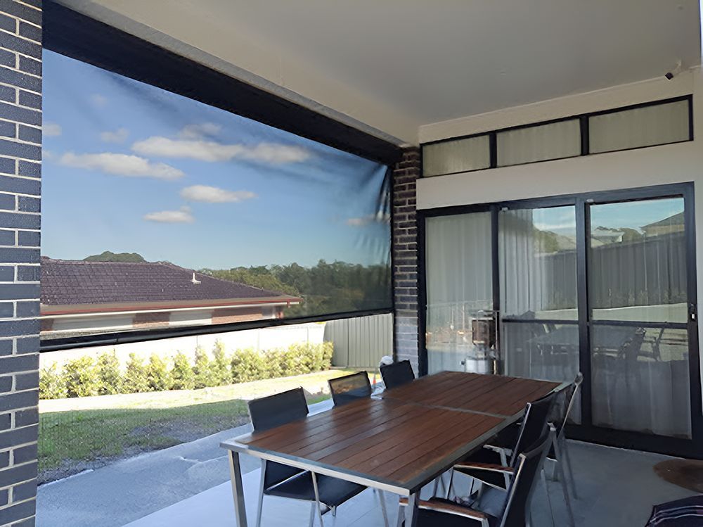A Patio With A Table And Chairs And A Sliding Glass Door — Ron Ayton Curtains, Blinds & Shutters In Shelly Beach, NSW